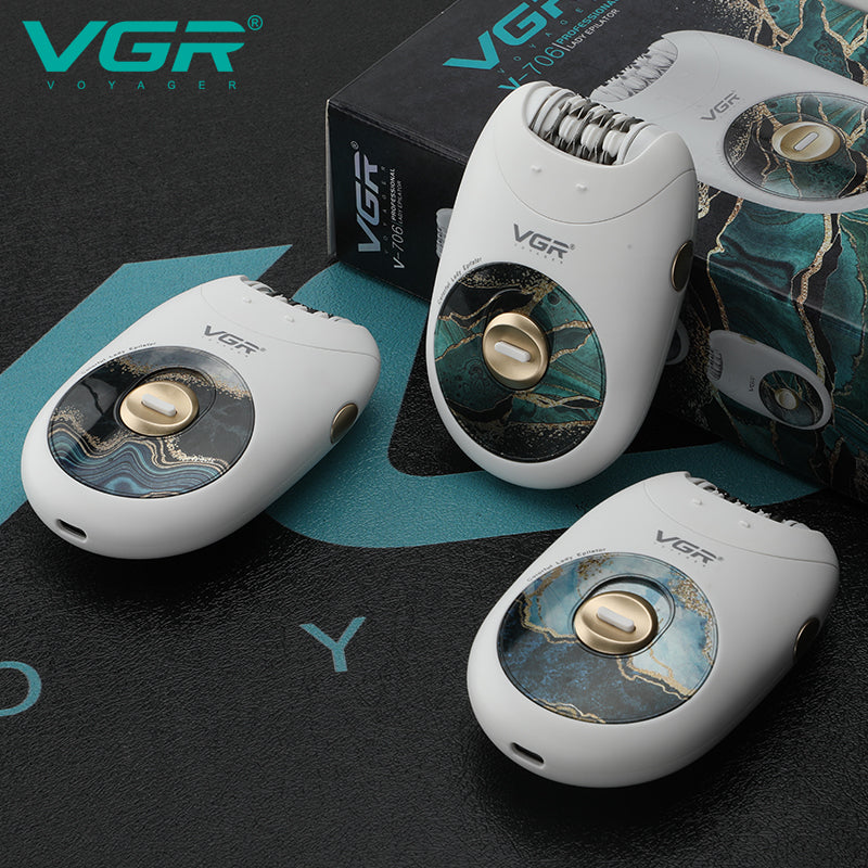 Three white VGR V-706 lady epilators displaying green marble and blue wave graphic accents beside packaging box