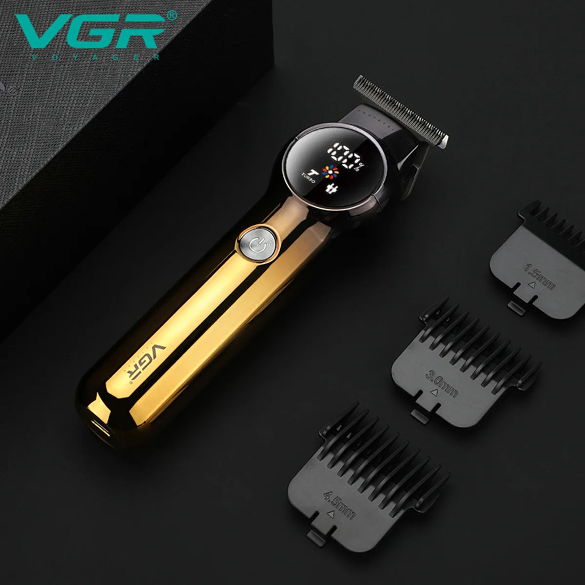 Gold and black VGR V-989 zero-gapped hair trimmer resting on dark background alongside 1.5mm, 3.0mm, and 4.5mm attachment combs