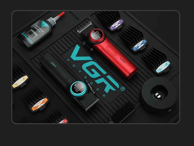 Overhead barber station flat-lay featuring red and black VGR V-001 hair clippers, blade oil, charging dock, cleaning brush, and guide combs arranged on a branded black rubber mat.