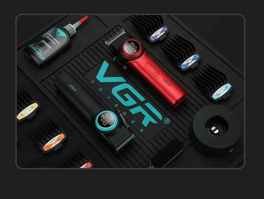 Overhead barber station flat-lay featuring red and black VGR V-001 hair clippers, blade oil, charging dock, cleaning brush, and guide combs arranged on a branded black rubber mat.