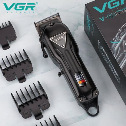 Top down physical presentation of the black all-metal VGR V-051 professional barber clipper positioned next to its original retail box and cutting guards.