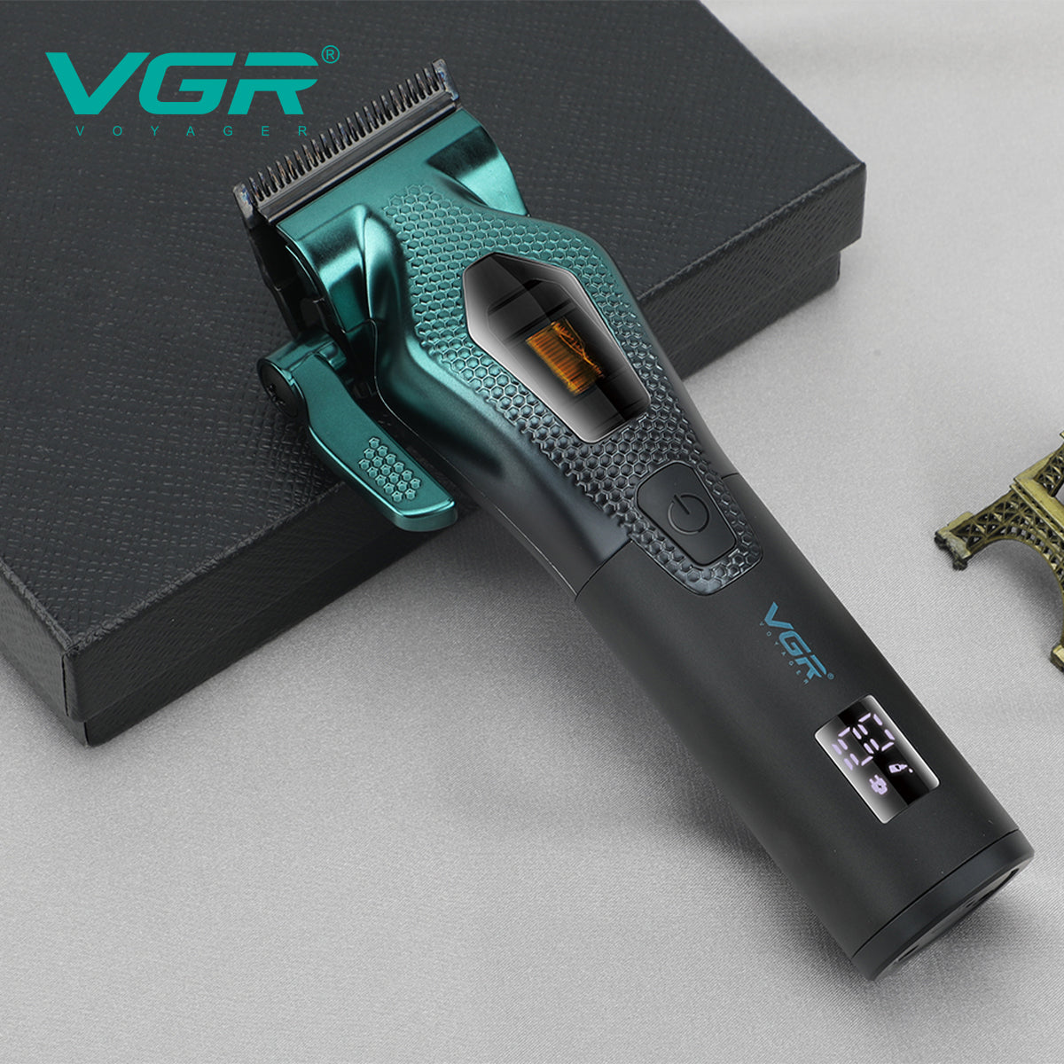Close-up of VGR V-271 hair clipper showing green textured body with clear motor window and illuminated digital LED power screen