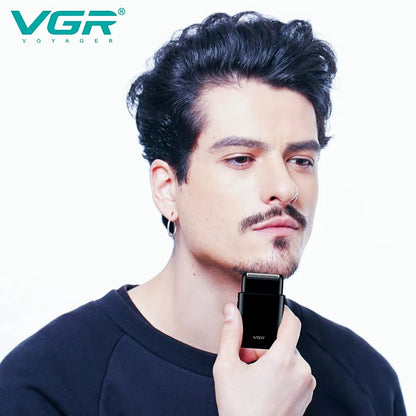 Model using VGR V-390 mini electric shaver for a clean chin shave. Portable professional shaving machine for men's daily grooming and styling.