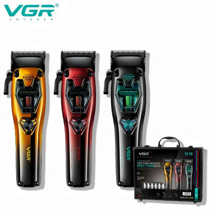 A full view of the VGR Voyager V-668 professional vector motor hair clipper shown in three metallic finishes: gold, red, and black, alongside its retail carry case and accessories.