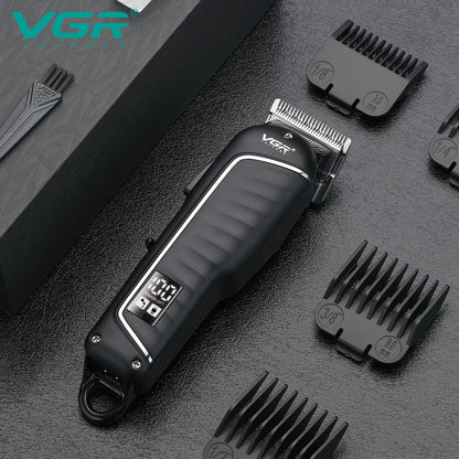 Black VGR V-683 professional hair cutting machine placed on a table with attachment shaving clips and a cleaning brush.