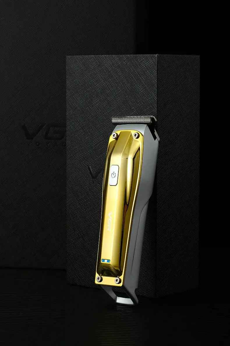 a premium vgr v955 gold cordless hair clipper leaning elegantly against its luxury black textured gift storage box.