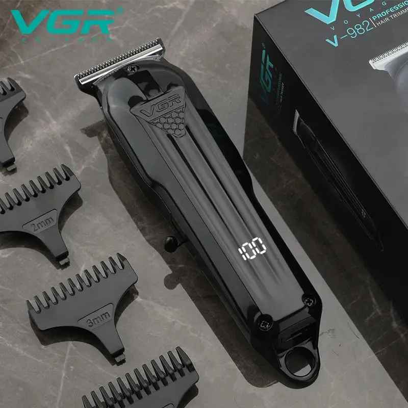 VGR V-982 zero-gapped carving trimmer resting on a stone surface beside black guide combs and the original VGR retail box.