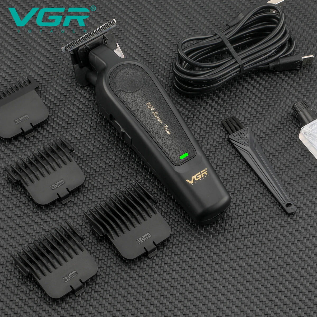 vgr v-995 cordless hair clipper laying down with four cutting guide combs cleaning brush and blade oil